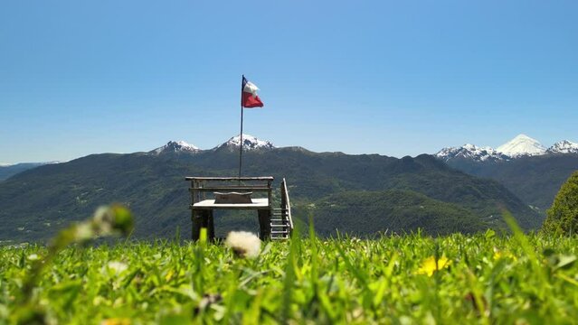 Drone view of Chilean flag and Villarica volcano in the beginning of route to Heart lagoon laguna corazon in Chile.