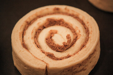Delicious uncooked cinnamon roll on a pan waiting to be cooked 