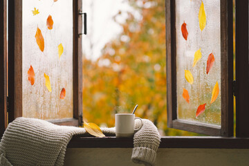 Sweet Home. Still life details in home on a wooden window. Sweater, hot tea and autumn decor. Autumn home decor. Cozy fall mood. Thanksgiving. Halloween. Cozy autumn or winter concept.