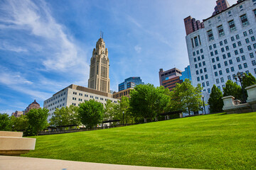 Fototapeta na wymiar Blue sky day with summertime shot of LeVeque Tower from the Scioto Mile Promenade