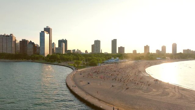 Epic shot of people playing volleyball in Chicago at lake Michigan