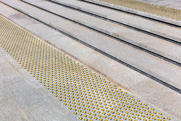 yellow limiter markings on stairs for visually impaired people