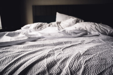 crumpled sheets of a hotel bed in the morning