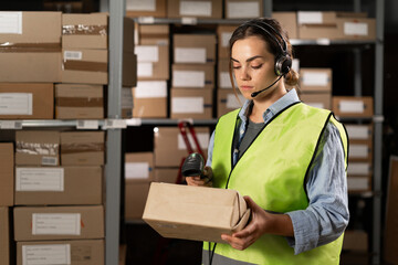 female worker in headset at logistics warehouse using digital tablet. against the background of...