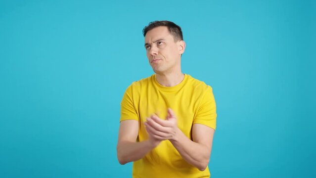 Disgruntled and disappointed man applauding ironically at camera