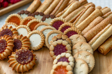 A variety of cookies on a wooden serving plate on the table. TOP video. Close-up.