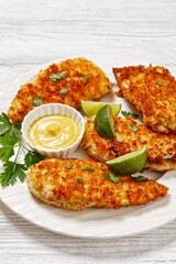 fried chicken cutlets on white plate, top view