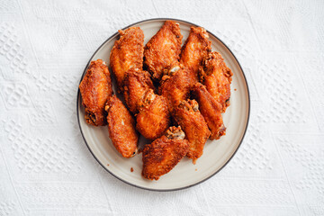 Fried chicken wings on a plate with tomato sauce