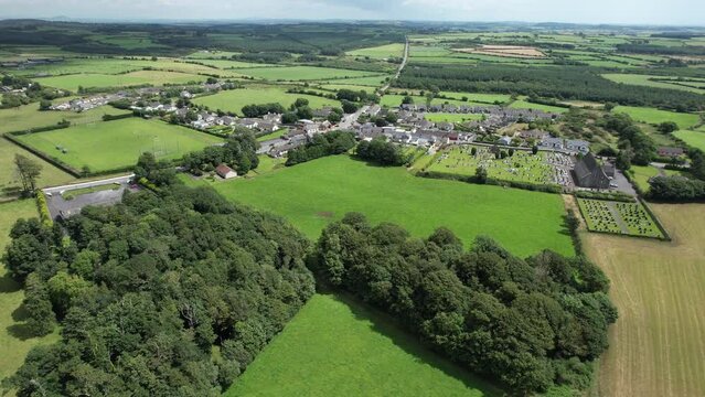 Drone establishing shot of Kill Village Co. Waterford Ireland a pretty little tourist village on The Copper Coast Drive on a warm summer day