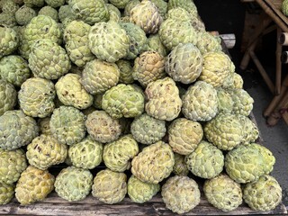 Pile of custard apple in the fruit market. Famous tropical fruit in Asia. High vitamin and nutrition.