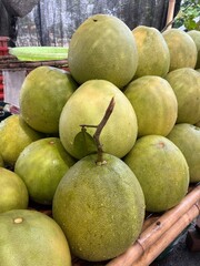 Pile of fresh pomelo fruit. Famous tropical fruit in Asian market. High vitamin C and nutrition. Refreshment dessert in summer.