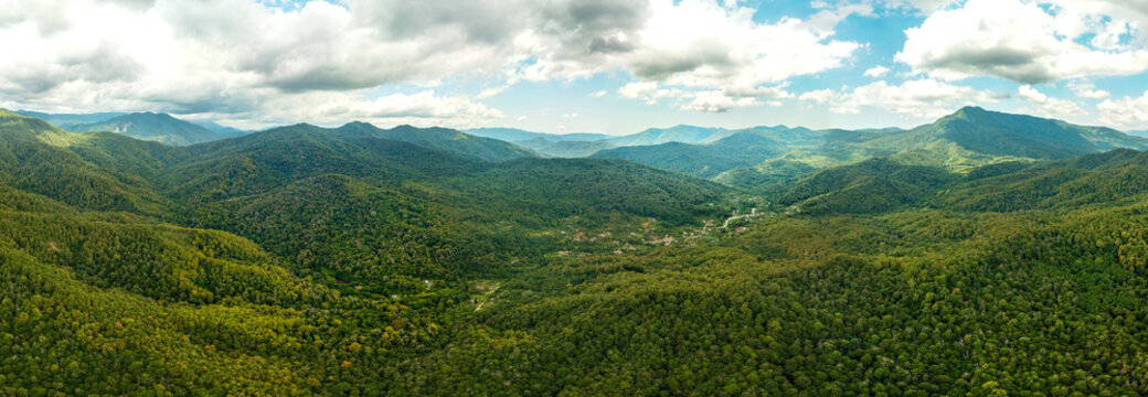 Valley of the Mountain River Shepsi among the Green Forest of the mountains of the Western Caucasus off the coast of the Black Sea Air panorama on a sunny summer day