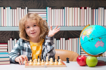 Chess school. Kid playing chess. Clever child thinking about chess. Kids early development.