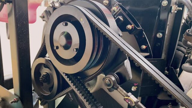 Close up detail of the vehicle engine fragment. Belt and pulley drive