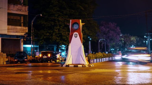 Surakarta City, Solo Indonesia timelapse view of Pasar Gede clock monument roundabout intersection, night market
