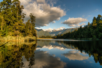 The scenic iconic Matheson Lake in Fox Glacier with the Southern alps in the background in the West Coast New Zealand