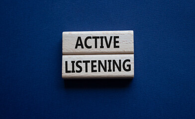 Active listening symbol. Wooden blocks with words Active listening. Beautiful deep blue background....