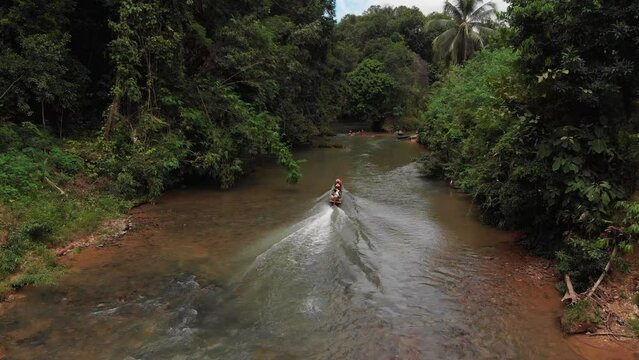kampung sampan in a rural river beside a longhouse