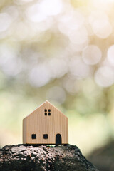 close up toy wooden house on wood, saving and manage to success business, home insurance technology, subprime mortgage crisis risk and problem concept