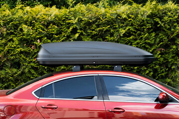 Side view, red car, sedan with roof rack. Equipment for travel. Concept of storage, transportation - obrazy, fototapety, plakaty