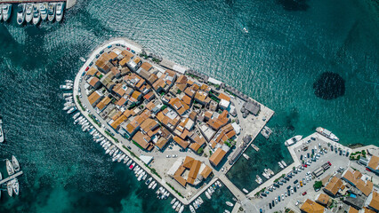Old city at the sea coast. Croatia Tribunj. Aerial drone view.