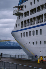 Coast bay view with modern cruiseship cruise ship liner Regatta in front of Alaska mountains on...