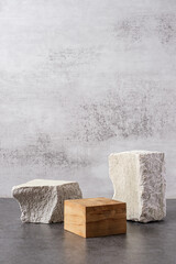 Rough stone and wooden box with sunlight from window on concrete wall and floor background,Copy space for product display