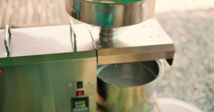 Man pouring seeds into Oil Press. 4k, slomo