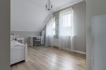Modern bedroom in a new house in bright colors with a minimum amount of furniture