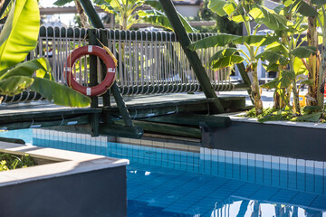A pool with a lifebuoy in a tropical vacation resort