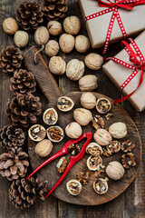 Whole and chopped walnuts on old wooden table. Flat lay