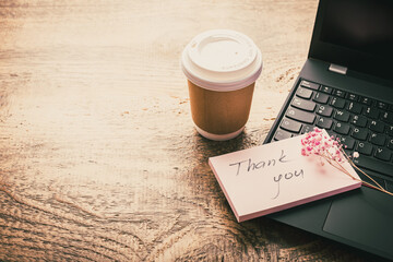 Thank you concept on the sticky note paper -  notebook and coffee cup