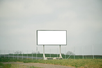 Blank billboard or road sign template on the highway. Empty billboard mockup for advertising located on the motorway