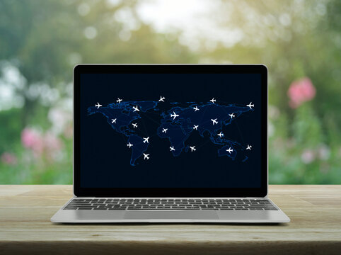 Flight routes airplanes connection and world map on laptop computer screen on table over blur garden, Business airplane transportation network online concept, Elements of this image furnished by NASA