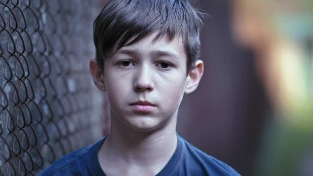 Profound Portrait of a Thoughtful Boy Engaging with the Camera Outdoors