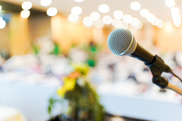 Wired microphone set up on the front of conference room close up with blurred background.  - obrazy, fototapety, plakaty