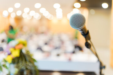 Wired microphone set up on the front of conference room close up with blurred background. 