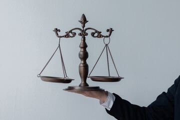 Close up of Male lawyers working at the law firms. Judge gavel with scales of justice. Legal law, lawyer, advice, and justice concept.
