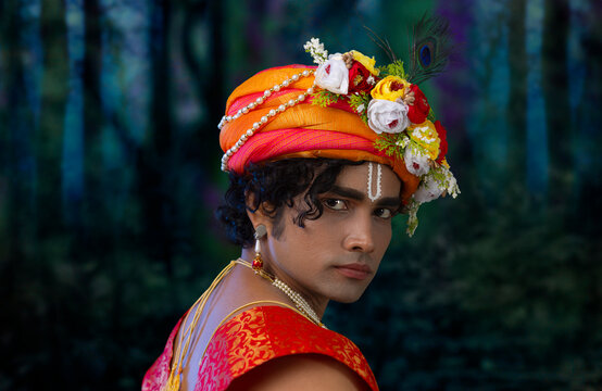 Close-up portrait of young man dressed up as Lord Krishna on the occasion of Janmashtami
