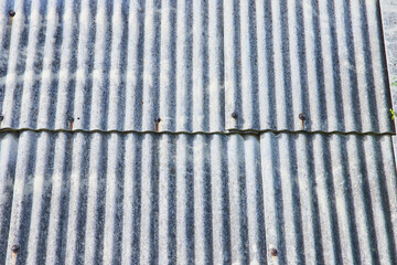 Wavy, crinkled, metal iron wall or roof, overlapping siding