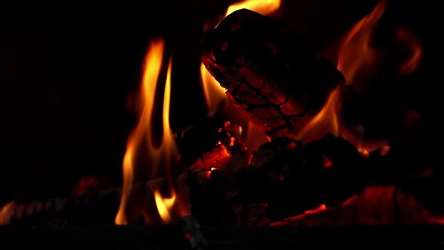 Cinematic shot of burning fire depicting playful dances of flames. Orange light of fire pierces darkness of night and beckons to sit around it Burning flame gives warmth and tranquility to environment