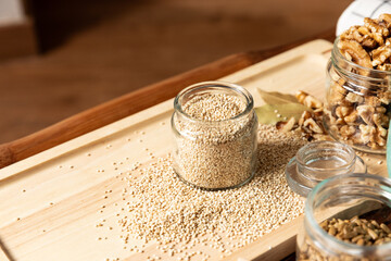 small jar with quinoa on rustic table top view. Healthy food and snack.