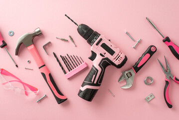 Acknowledging the vital role of female workers on Labor Day. Top view snapshot capturing various building tools on a pink isolated backdrop, with copyspace for advertising or text messages