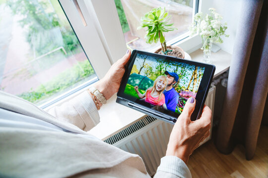 Woman talking on video call with granddaughter through tablet PC