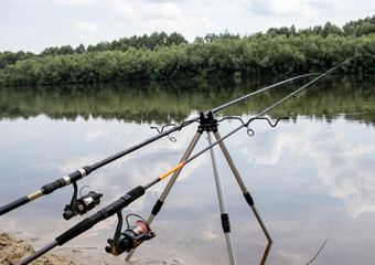 fishing rods on the background of the river with nature