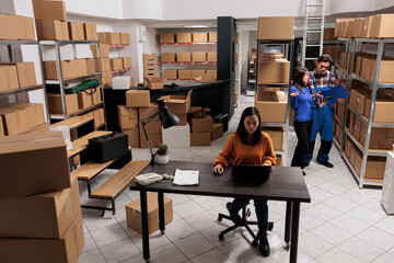 Warehouse asian employees team preparing order parcel for shipment in retail business storage room....