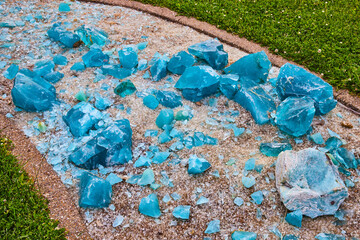 Gorgeous turquoise blue shards resting on a river of broken clear glass fragments