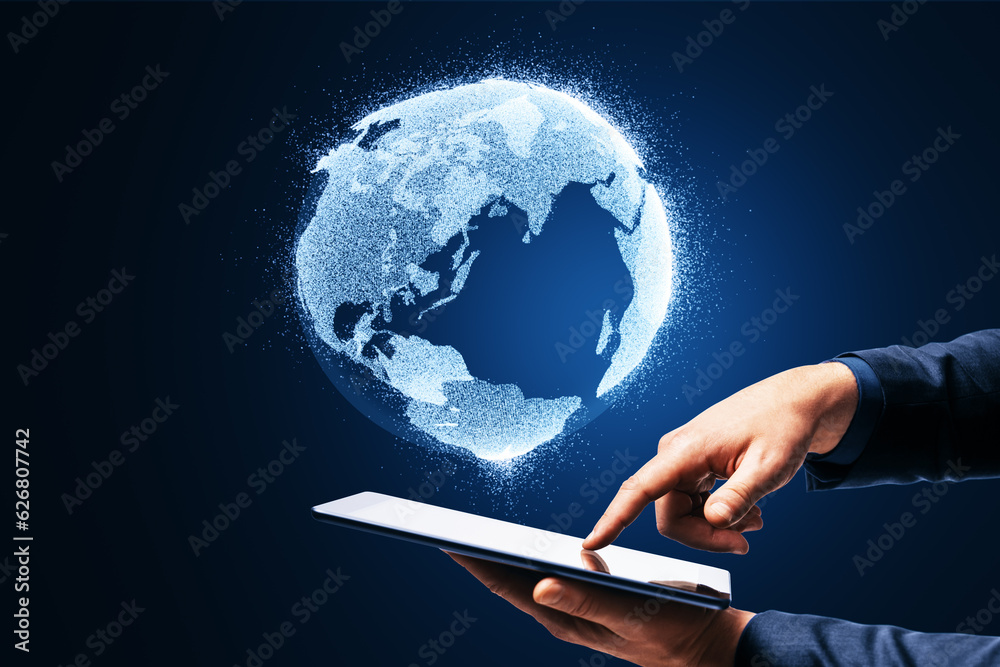 Poster close up of businessman hand holding and pointing at mobile phone with glowing globe hologram on blu