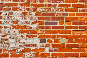 Fierce orange and red brick wall with exposed white of underlying bricks background asset