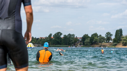 Cutout of a triathlete in a wetsuit before a triathlon